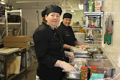 Keittiömestari Mari Sadeharju ja ravintolapäällikkö Anna Angervisto valmistavat ulosmyyntinä tarjoiltavan ruoan.