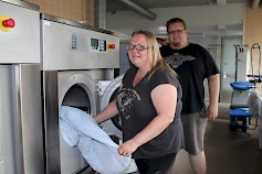 Sanna Juttuniemi vastaa Evijärven Pesulan toiminnasta. Aku Juttuniemi taas operoi autokorjaamon ja laiturien valmistuksen parissa.