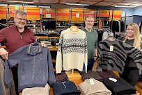 Vaatetusliike Siltalan toimitusjohtaja Jere Siltala näyttää komeaa miesten neulepuseroa. Veli Janne Siltala esittelee näyttävää kuvioneuletta ja sisar Janniina Siltala nappasi naisten mallistosta pehmoisen ja juhlavan neuleen. Veljeksillä on itselläänkin yllään puserot Siltalan laajasta valikoimasta. Iloiset sisarukset muistuttavat myös, että lahjakortinkin voi Siltalasta hankkia, ellei sopivaa pehmopakettia onnistu löytämään.